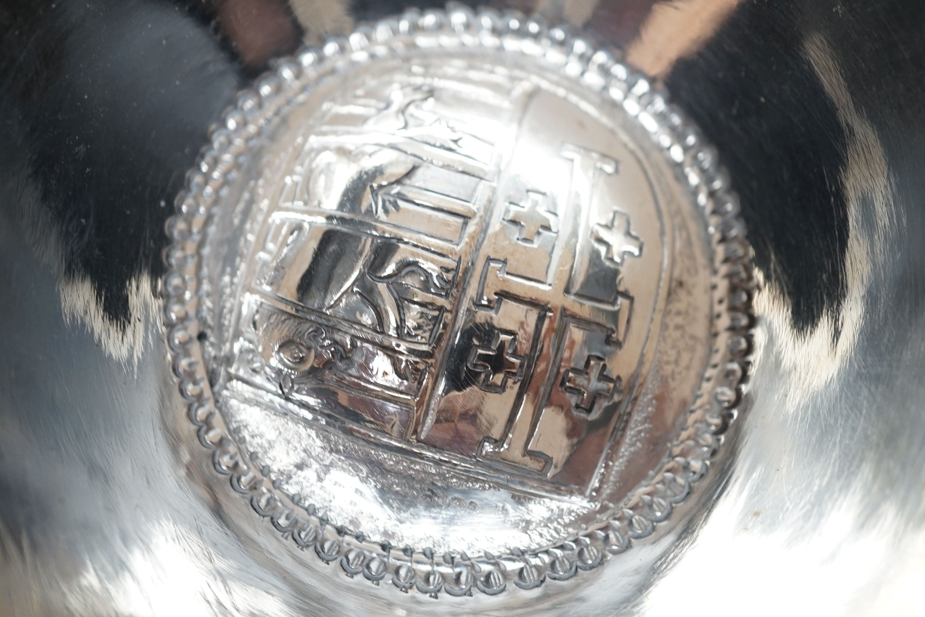 Four small Rangoon white metal bowls together with a simile basket and six small white metal bowls with heraldic motifs, gross 24.5oz.